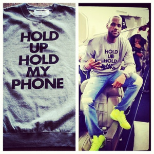 ... James Wears I AM NAMELESS Brand “Hold Up Hold My Phone” Sweater