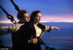 Jack Dawson - wearing a different jacket - again stands at the bow ...