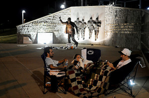 Kevin Berkon, Courtney Brenner and Mike Elliot sit by the Joe Paterno ...