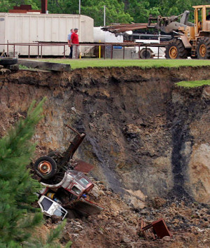truck falls into a giant sinkhole as a tractor is used to remove ...