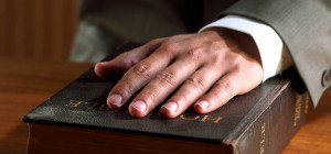 hand-on-bible