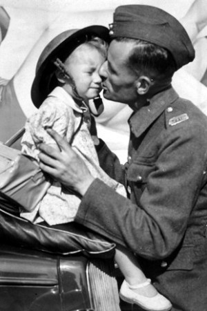 farewell kiss -A soldier kissing his daughter goodbye before he ...