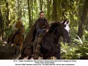 Eragon (Ed Speleers, left) and Brom (Jeremy Irons) ride to face a ...
