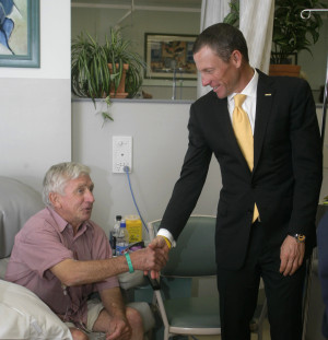 Armstrong greets a cancer patient in 2009. [Brandon Malone/Reuters]