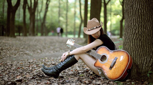 Sad girl with guitar lonely in jungle