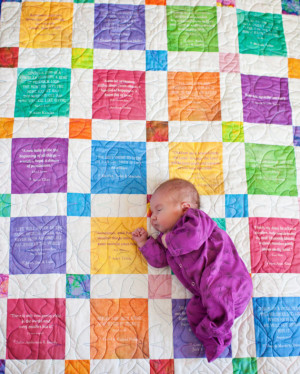 Baby quilt with fun quotes or personal mesages on each square.
