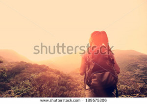 hiking woman enjoy the beautiful view at mountain peak - stock photo