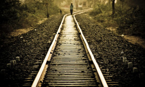 lonely girl walking on railway track