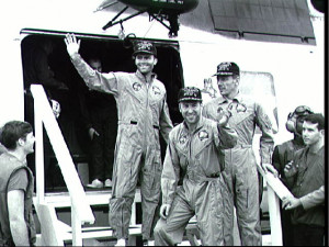 ... . Exiting the helicopter are (from left) Haise, Lovell and Swigert