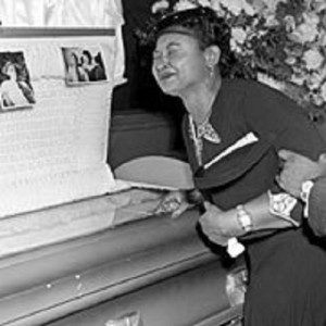 Emmett Till's mother at his open coffin.