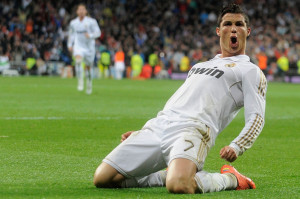 Cristiano Ronaldo celebrating a goal in a white Real Madrid jersey.