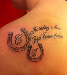 Horse shoes and saying tattoo; shoulder tattoo