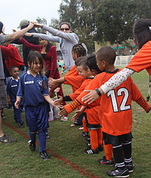 ... line up and touch hands after a game to learn about good sportsmanship