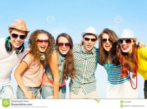 Group of young people wearing sunglasses and hats hugging and standing ...