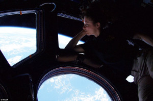 Homesick: Astronaut Tracy Caldwell Dyson peers down at Earth from her ...