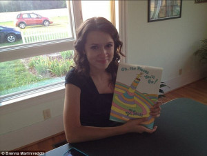 Brenna Martin shows off the 13-year-old copy of the book which her ...