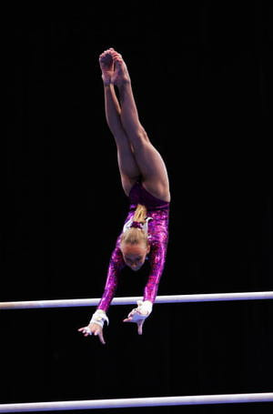 Gymnast Nastia Liukin does a Pak salto on bars at the 2004 Nationals ...