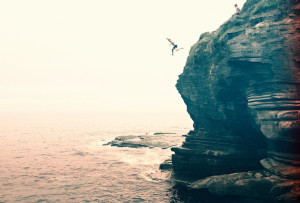 jedd_cooney_guy_jumping_into_ocean_from_cliff