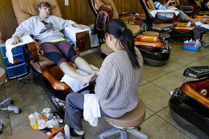 Julie Luu, right, gives a pedicure to a customer at Sun Nails in ...