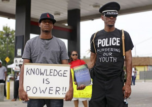 Demonstrators protest the shooting death of 18-year-old Michael Brown ...