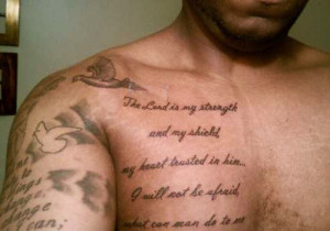 ... arm and chest of the guy are covered with his favorite bible verses