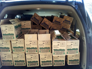 Very full back of car with Girl Scout cookies