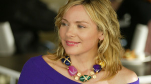 Samantha Jones in Ungaro top and stone necklace by Versace
