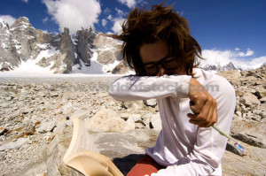picture of a nerdy woman with messy hair and horn rim glasses reading