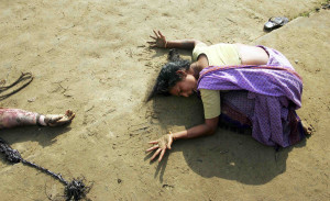 An Indian woman mourns beside a relative killed in the Dec. 26, 2004 ...