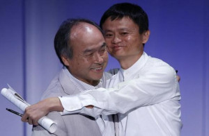 SoftBank Corp. Chief Executive Masayoshi Son (L) hugs Jack Ma, founder ...