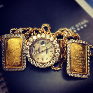 Yo Gotti’s Iced Out Gold Bar dog tags and Rolex Day Date II.