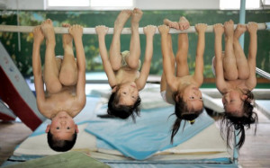 ... hanging upside down on a bar, resting during gymnastics training