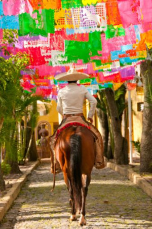 Destination wedding Mexico: Charro with colorful papel picado banners ...