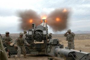 An M198, 155mm, towed howitzer being fired by US Army troops.