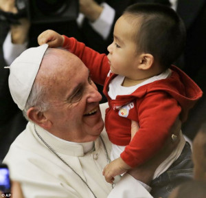 What's this white thing on his head? Pope Francis held a child in his ...