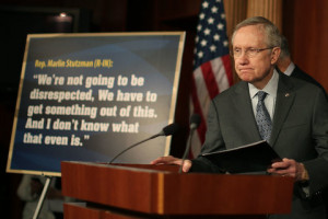 Harry Reid stands next to a quote from Marlin Stutzman during a news ...
