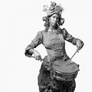 ... am a statue. When tipped I come to life and play the snare drum