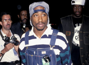 Tupac Shakur wearing denim dungarees