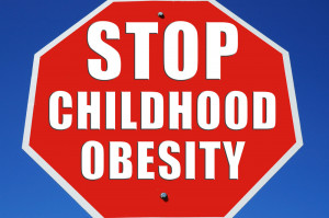 red and white stop sign with the words, STOP CHILDHOOD OBESITY