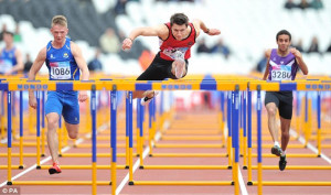 Leap forward: Andrew Pozzi (centre in red) clears a hurdle on his way ...