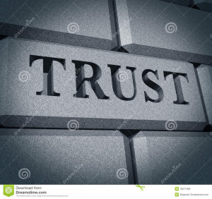 Trust text embossed into a wall of solid stone representing confidence ...