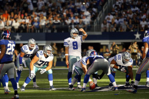 Dallas Cowboys quarterback Tony Romo (9) shields his eyes from the sun ...