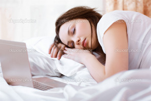 Sleeping girl with laptop - Stock Image