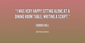 was very happy sitting alone at a dining room table writing a