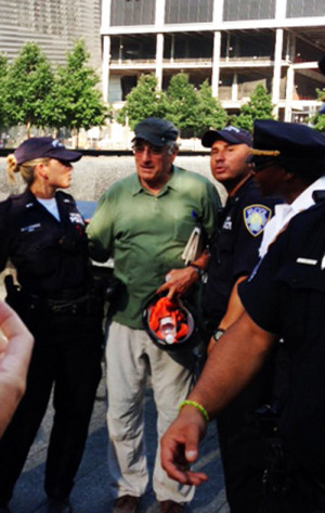 Bob talks with Port Authority officers in front of the reflecting pool ...