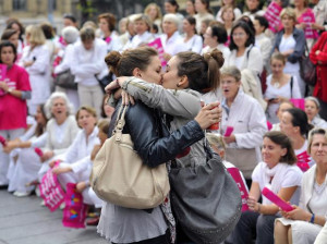 Lesbian couple kisses in front of a anti-gay protest in France.