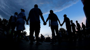 : People stand in prayer after marching about a mile to the police ...