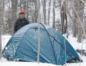 Jason checks out Mark’s tent during light snow flurries at Peaked
