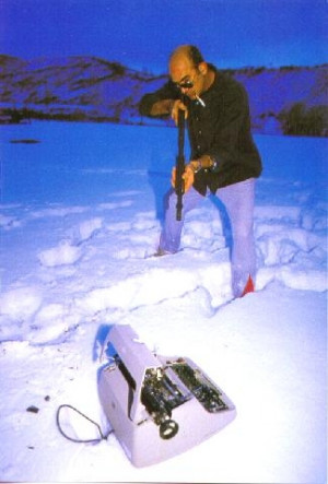 writer Hunter S Thompson aims gun at typewriter