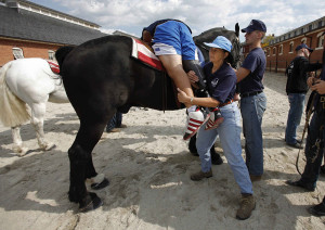 ... Cain is helped by Mary Jo Beckman after riding horse, October 2010